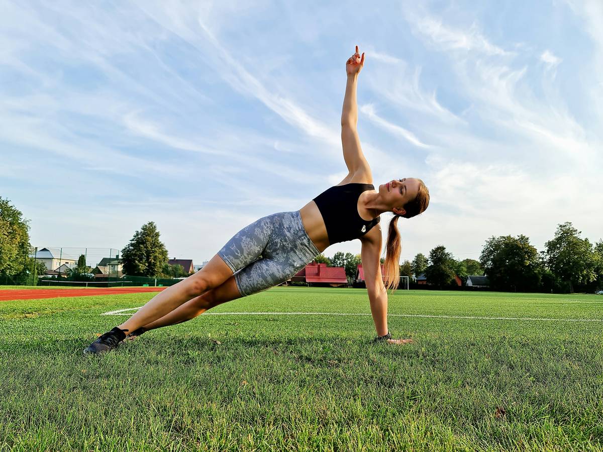 Woman preparing sustainable yoga mat cleaning gym solution in glass jar with natural ingredients