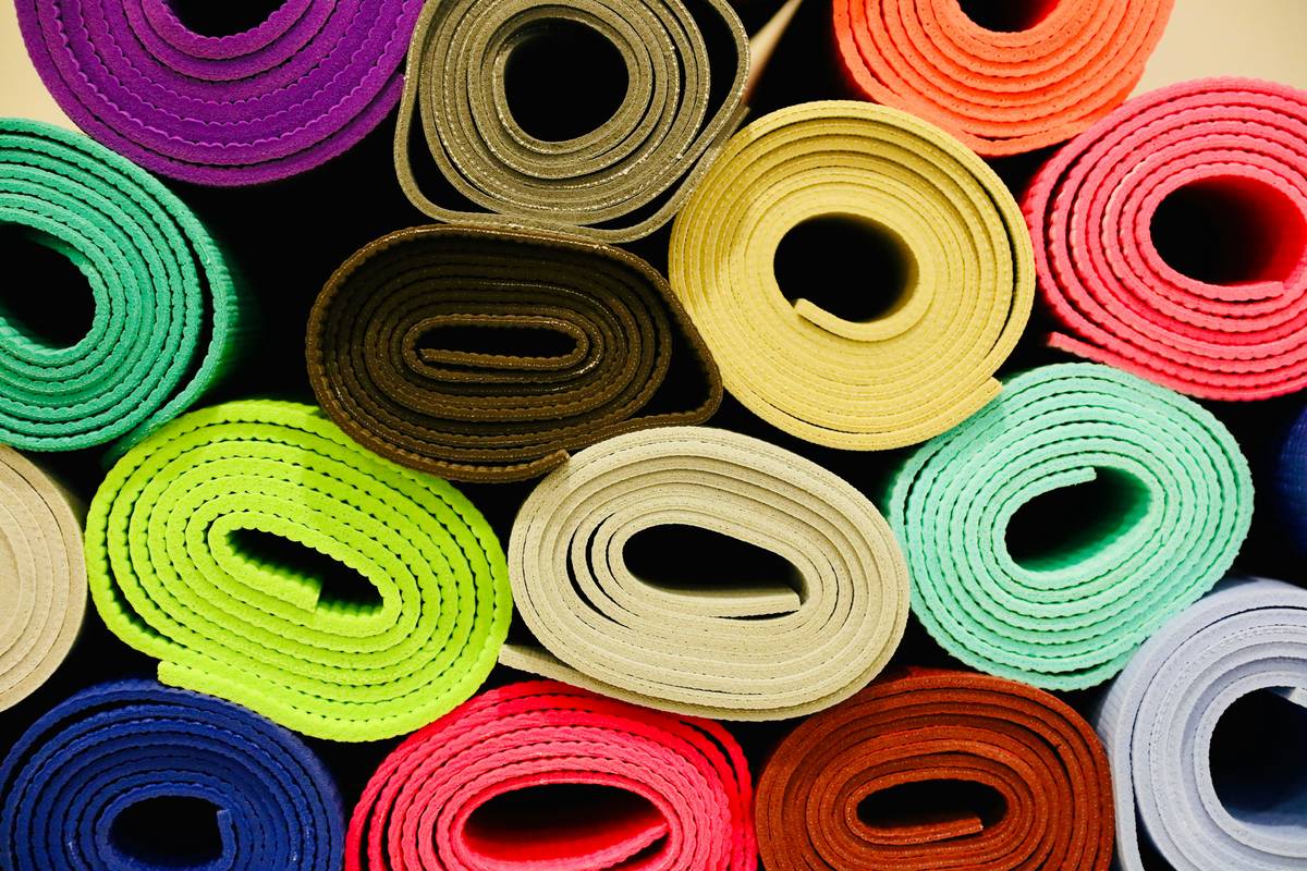 yoga eco rubber mat being gently wiped with microfiber cloth using natural cleaner